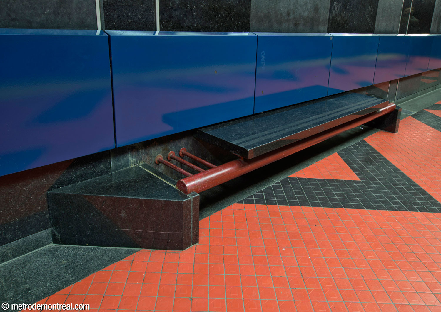 One of Michel Morelli's unique platform benches in black granite and red steel.