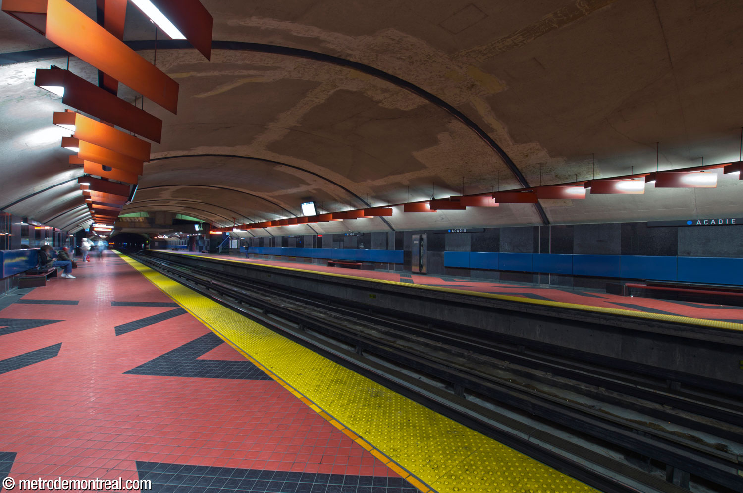 The trainroom, looking south from the Saint-Michel platform, with the bold colours and patterns of the walls, floor, and lighting on display.