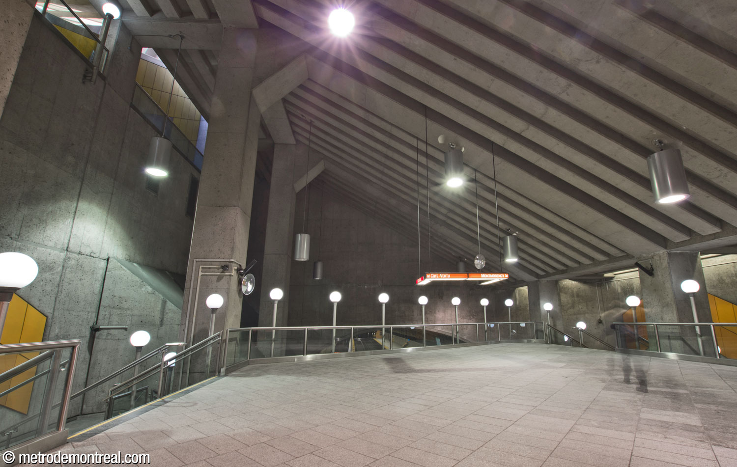 The main volume viewed along the mezzanine level. The roof slants upward, with the walkway at the upper ridge of the volume.