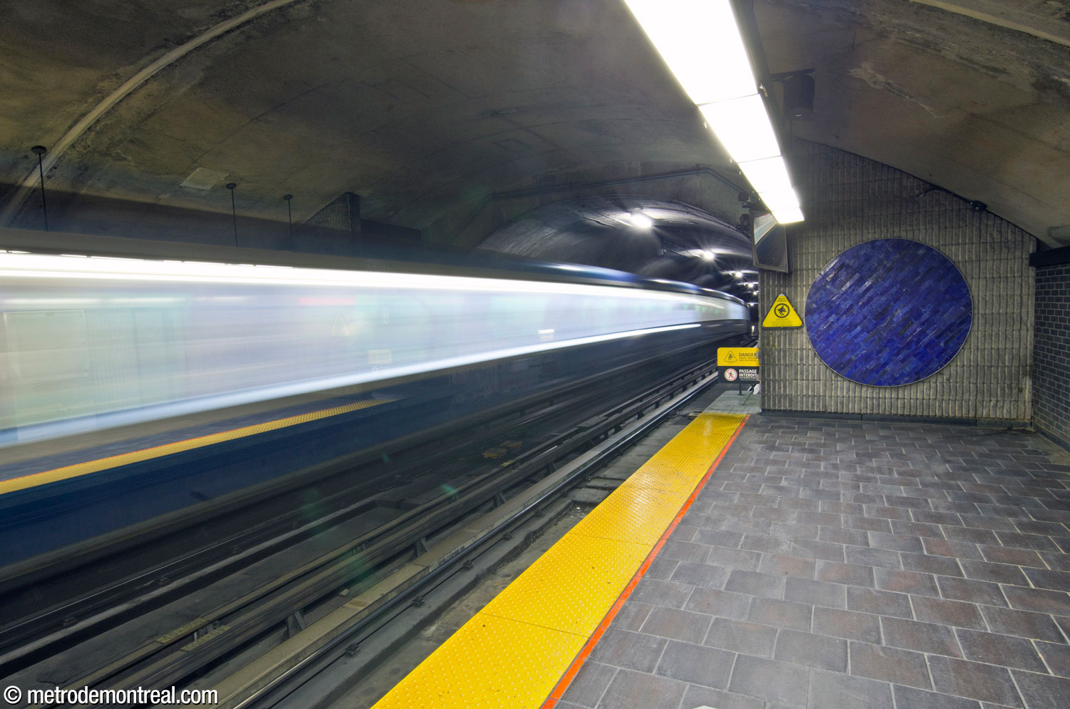 A bright blue tiled circle on the wall at the end of one of the platforms.