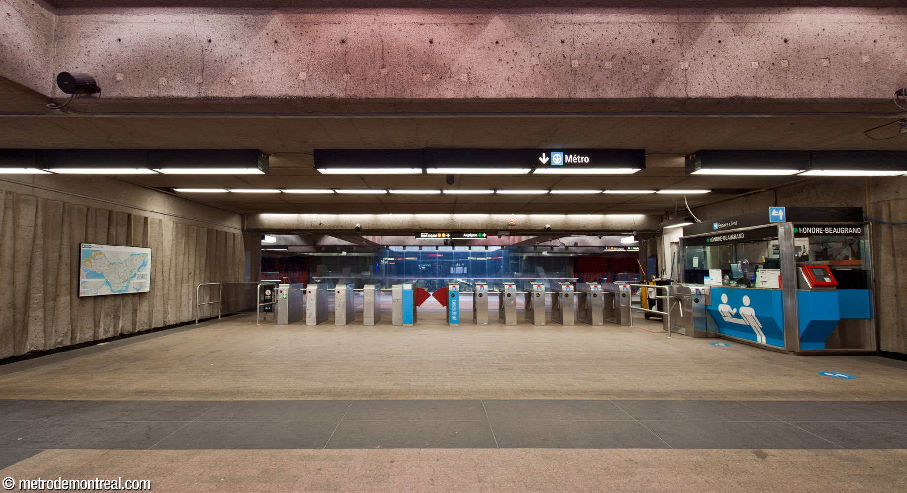 The broad ticket hall and the gateline crossing its full width.