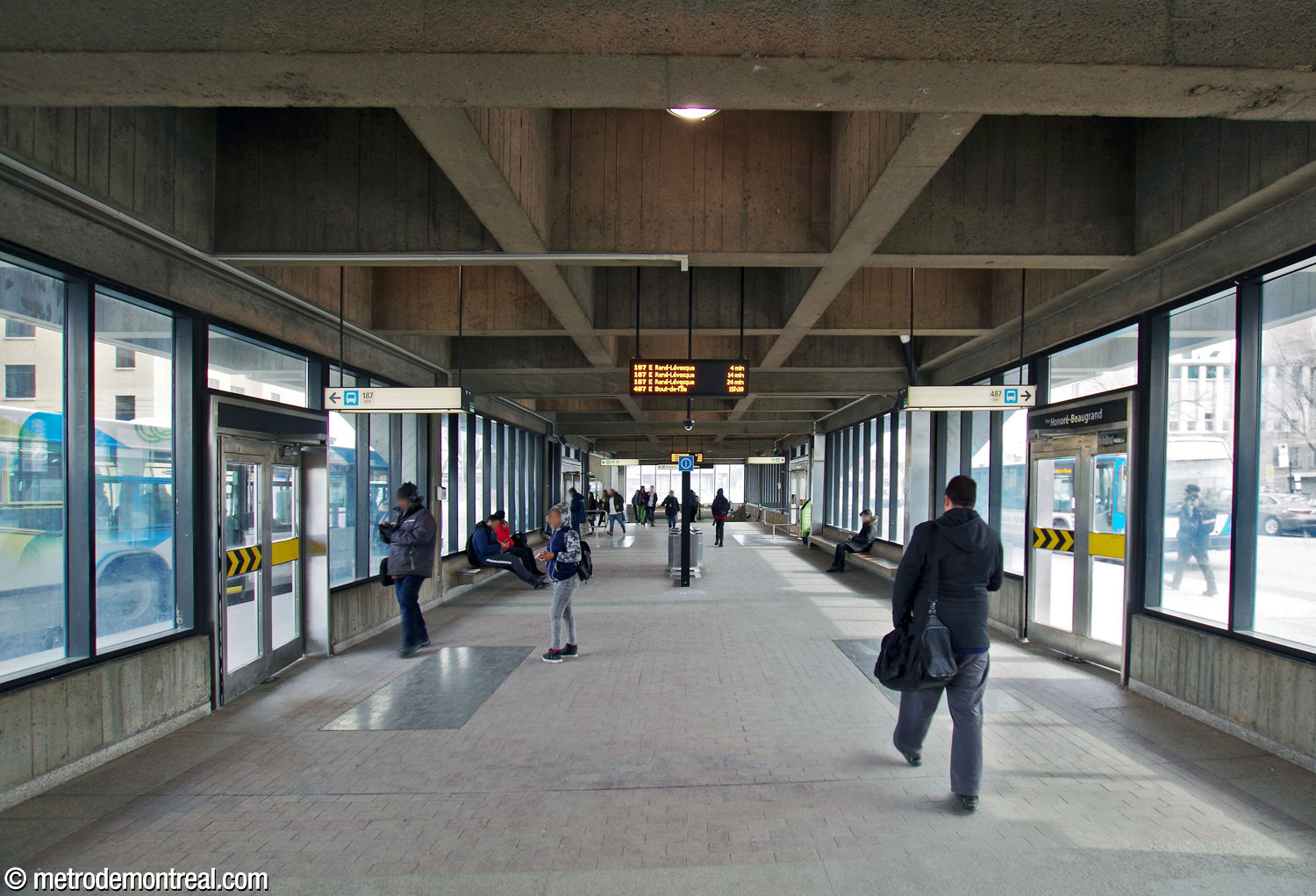 Interior of the elongated, open, abundantly windowed space of the Honoré-Beaugrand headhouse, facing south toward the escalators to the station.