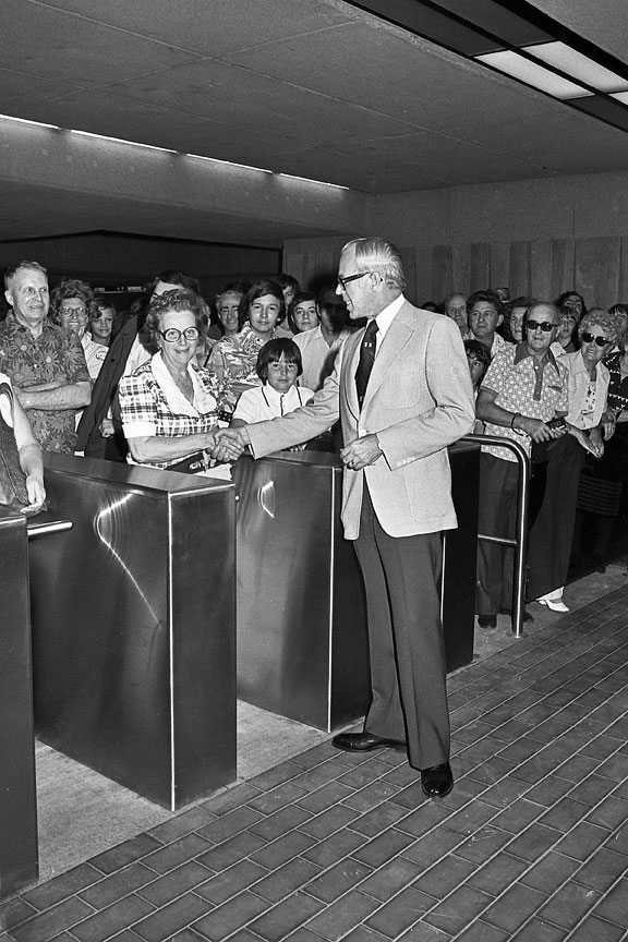 CTCUM chairman Lawrence Hanigan welcomes the first passengers to enter the station on its opening day, June 6, 1976.