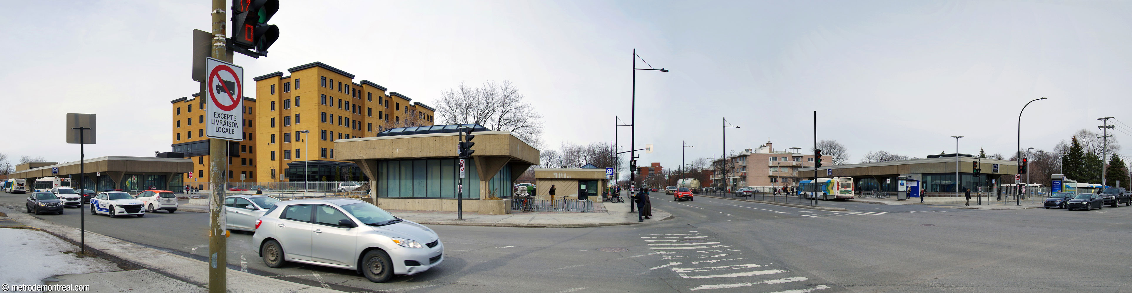 Panorama of the station's headhouses along Rue Honoré-Beaugrand. At left, the Honoré-Beaugrand entrance and bus loop; centre, a light shaft and the Sherbrooke Nord entrance; at right, the Sherbrooke Sud entrance and its own bus loop.