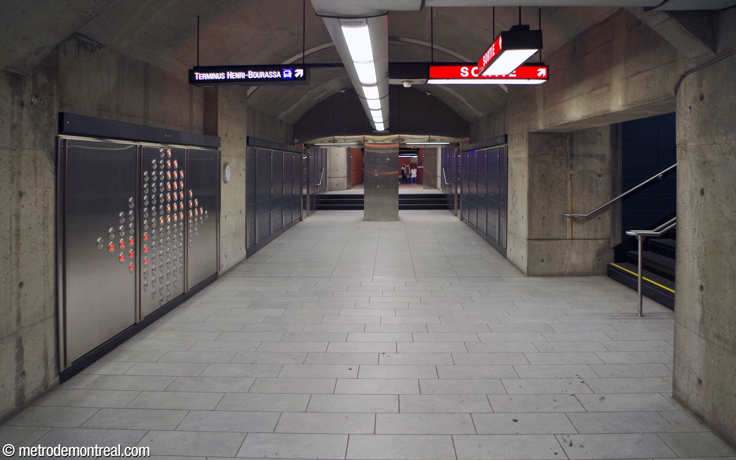 The corridor connecting the terminus platform, centre, with the Montmorency platform, behind the viewer. One of the sections of Axel Morgenthaler's light installation .98 is at left; at right, stairs lead up to the tunnel to the east ticket hall.