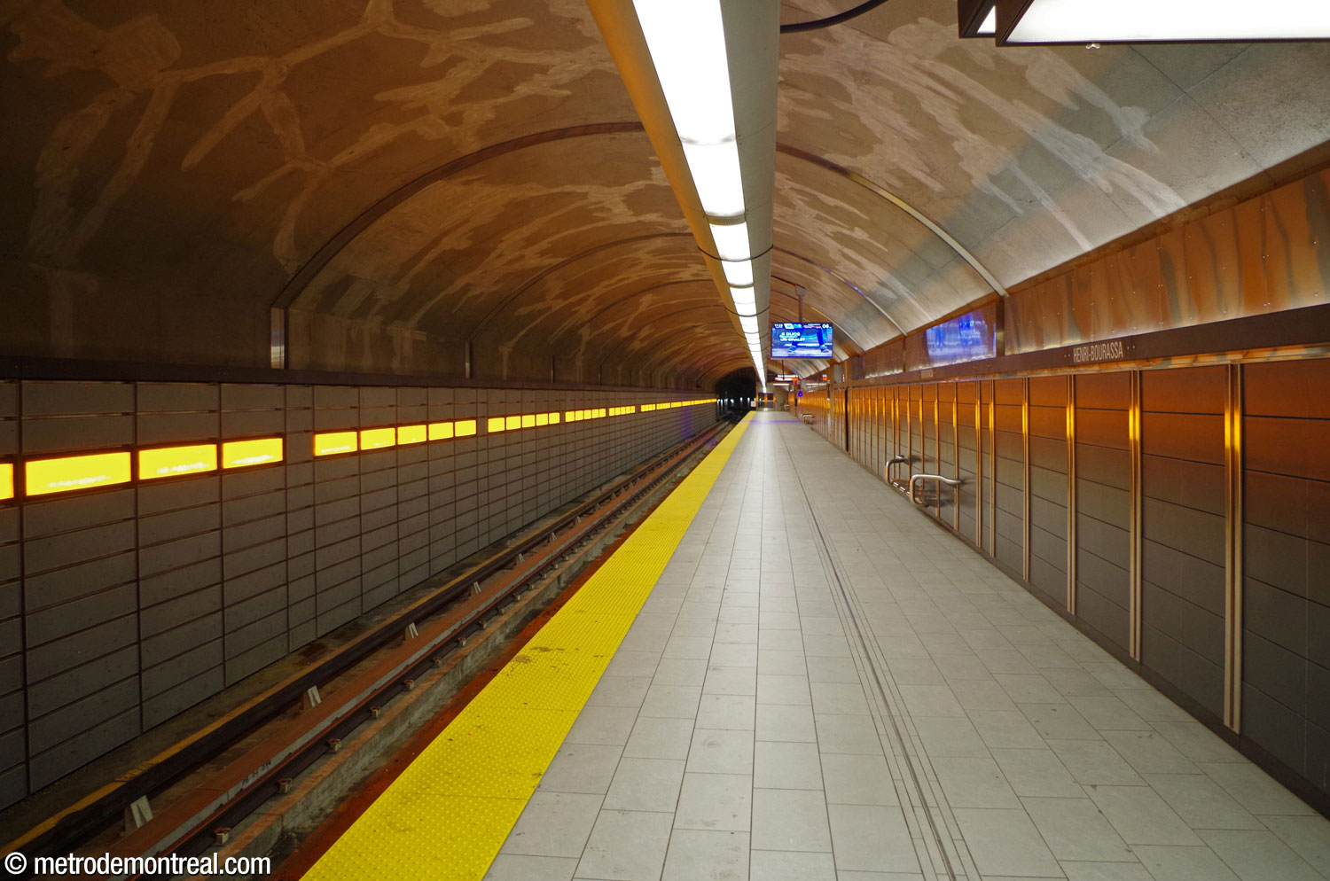 The Montmorency platform. The bright orange lights over the tracks reflect off the platform wall.