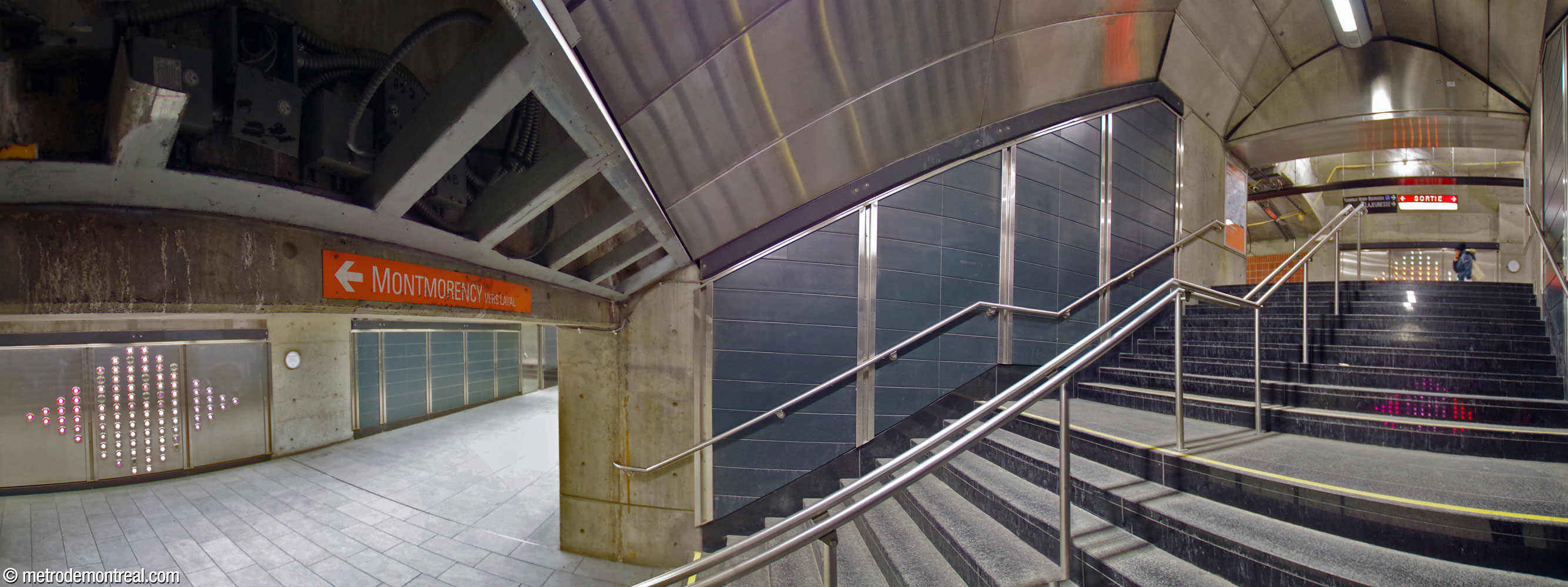 A panoramic view of the staircase linking the tunnel between the terminal and Montmorency platforms and the tunnel to the east ticket hall. The two sections of Axel Morgenthaler's light installation .98 are seen facing the top and bottom of the stairs.