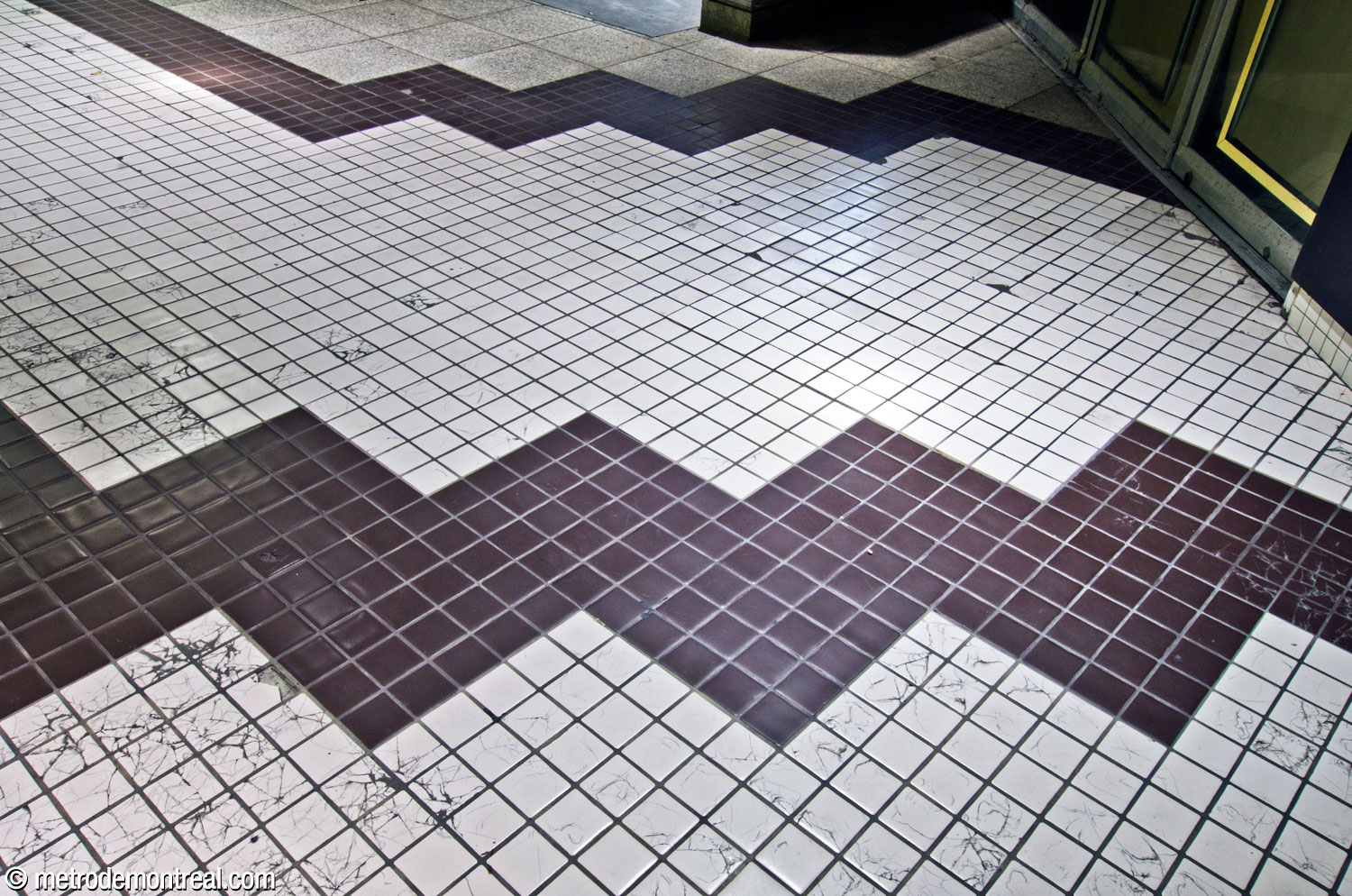 Un motif de zigzag fait de carreaux noirs et blancs au niveau du palier de l'accès sud.