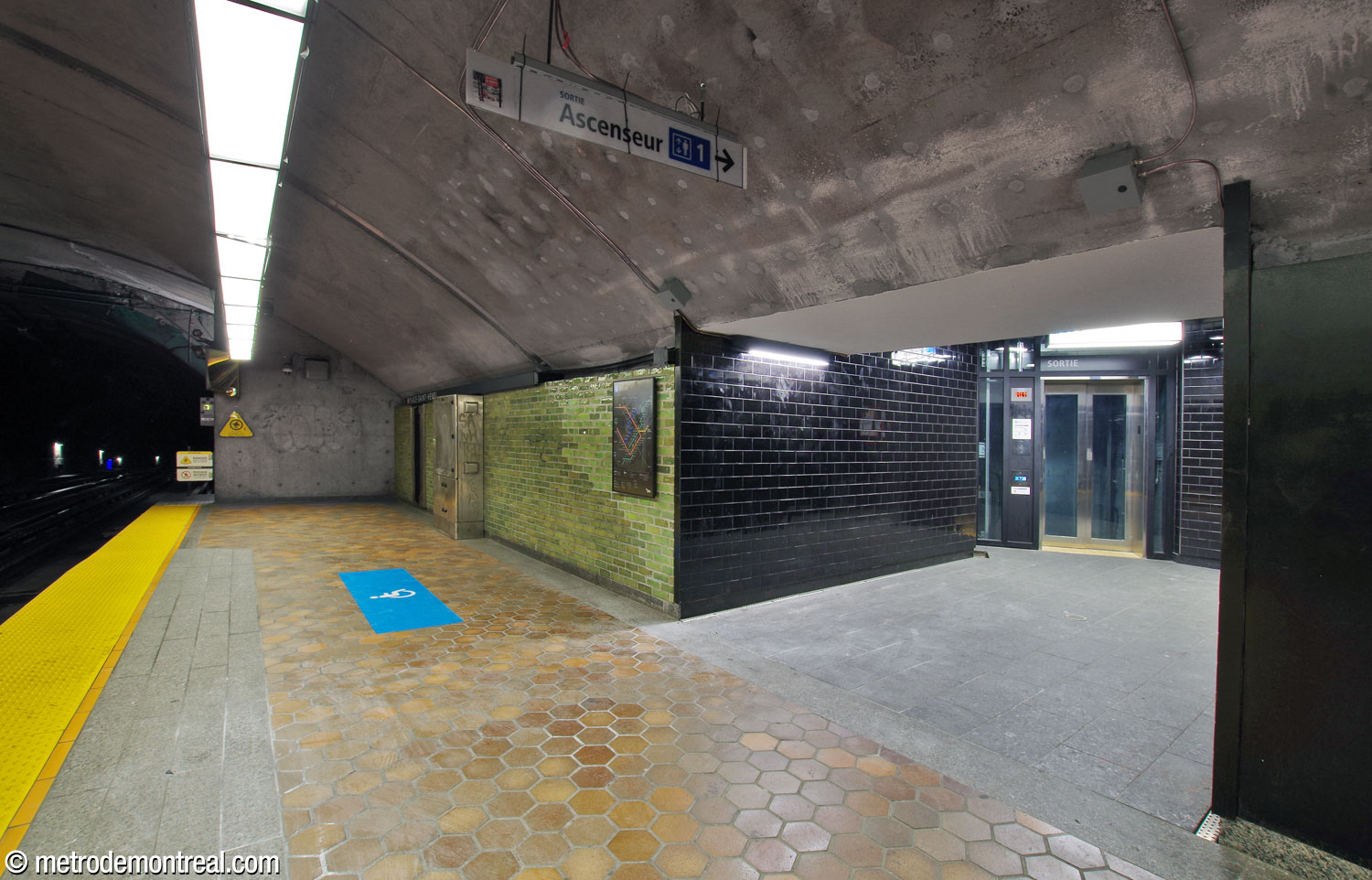 The entrance to the elevator at the head of the Montmorency platform. The elevator niche is clad in black tiles that stand out from the coloured glazed bricks along the platform.
