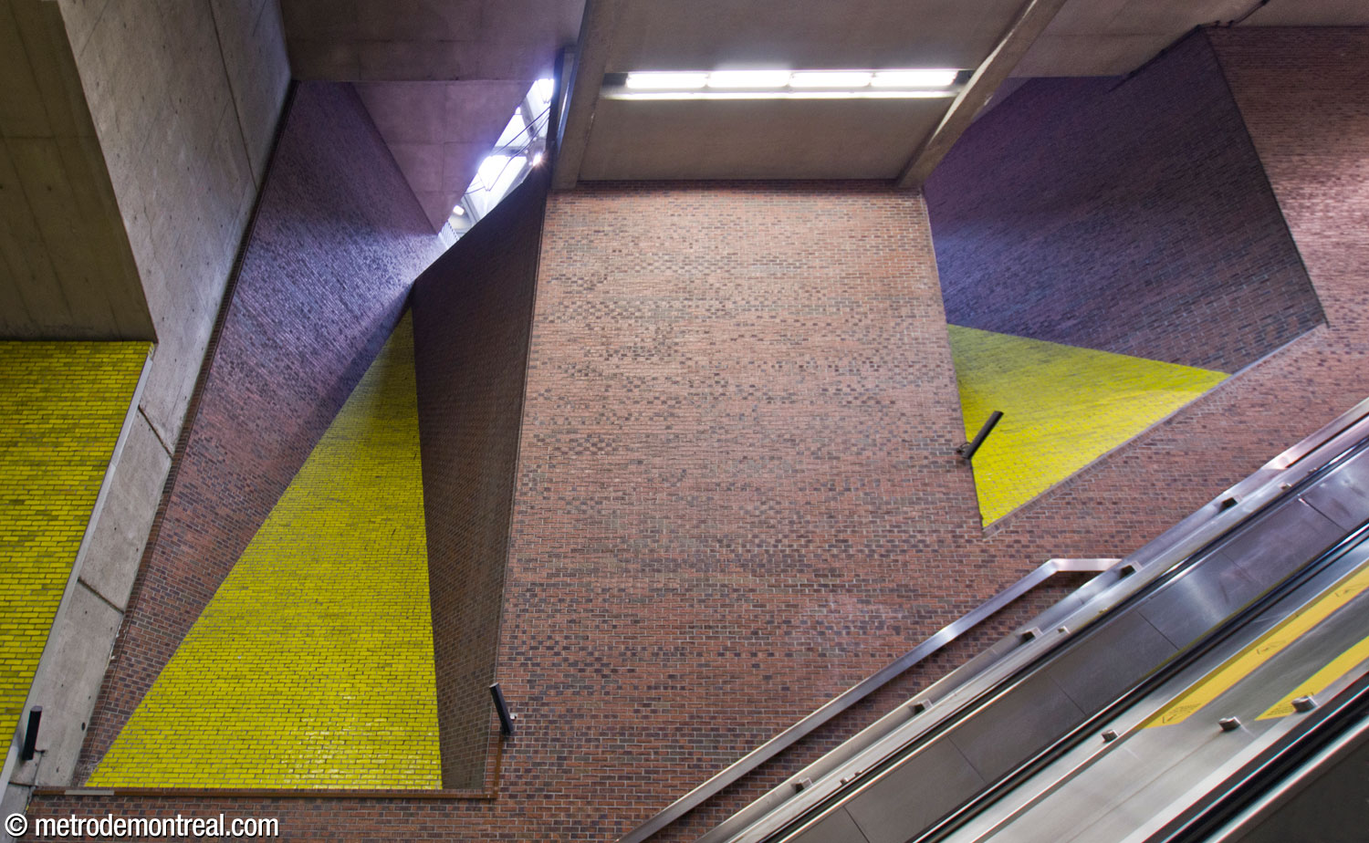 The tall triangular light shafts over the escalator well to the Montmorency platform admit sunlight from the skylights in the main headhouse.