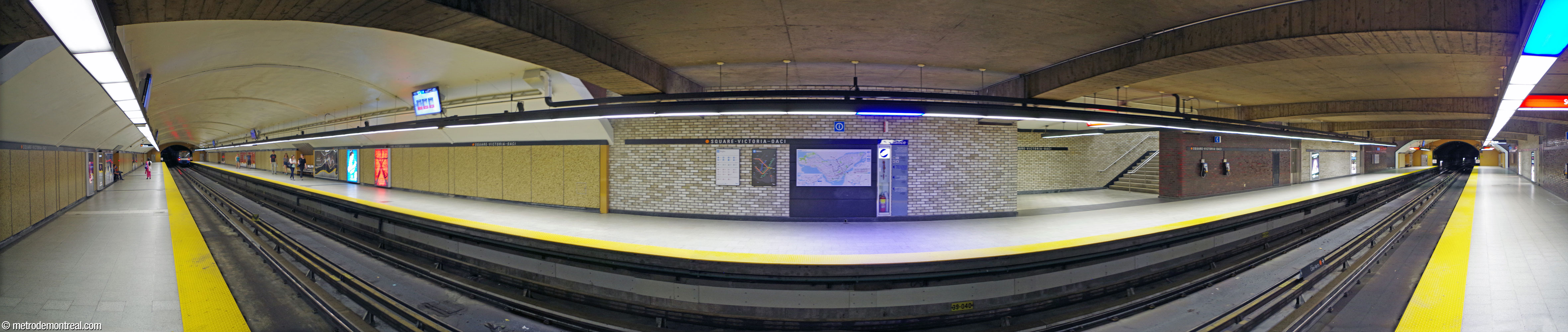 Vue panoramique des quais. Les murs sont parés de mosaïque de couleur or sur la majorité de la longueur des quais, construite en tunnel. Les sections dans le volume principal sont revêtues de brique glacée de couleur beige et marron pourpre.