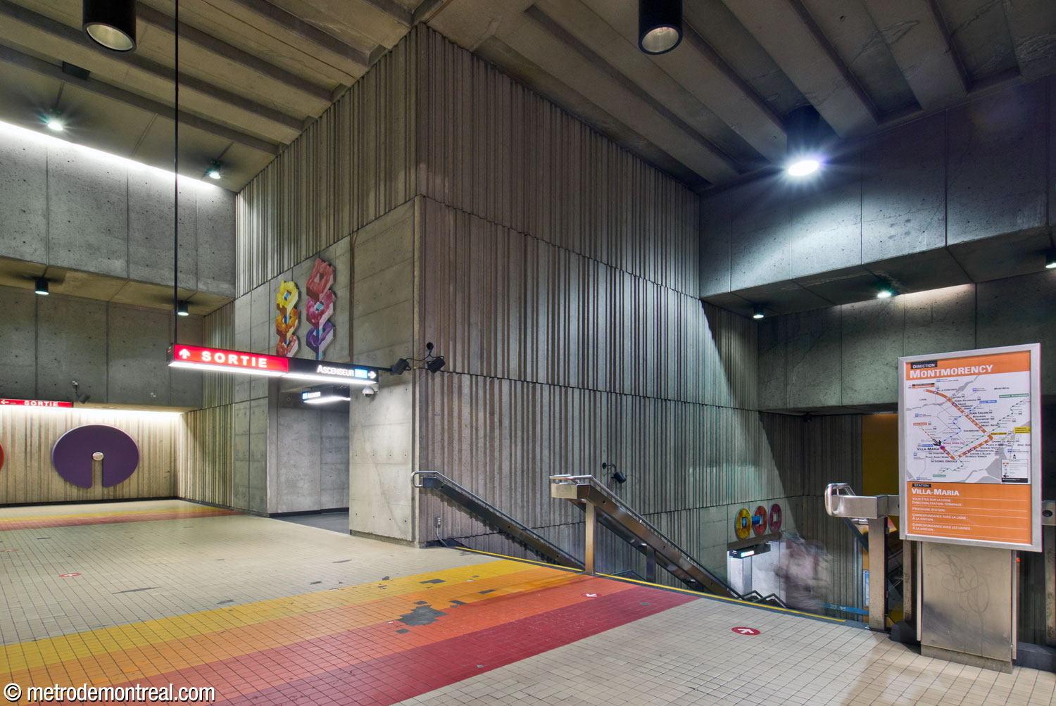 The west end of the main volume, above the stairs to the Montmorency platform. Two sections of Marianne Chevalier's artwork La correspondance des strates are located over the openings leading to the elevator serving that platform.