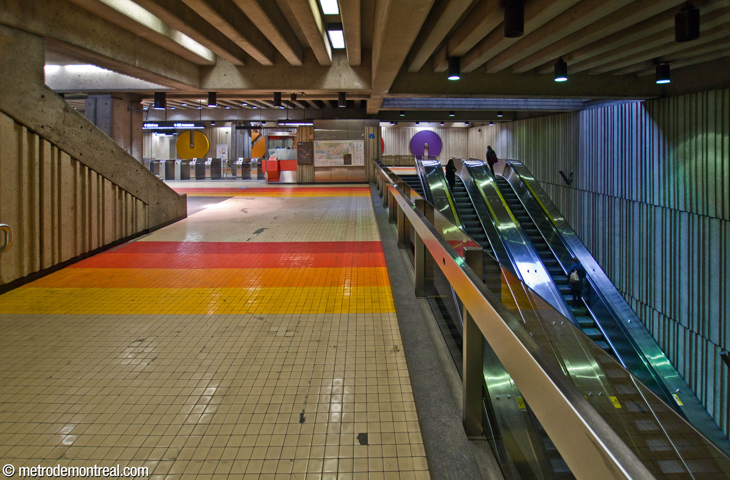 View of the ticket hall overlooking the large stairwell leading down into the station, seen from the walkway to the elevator up to street level.